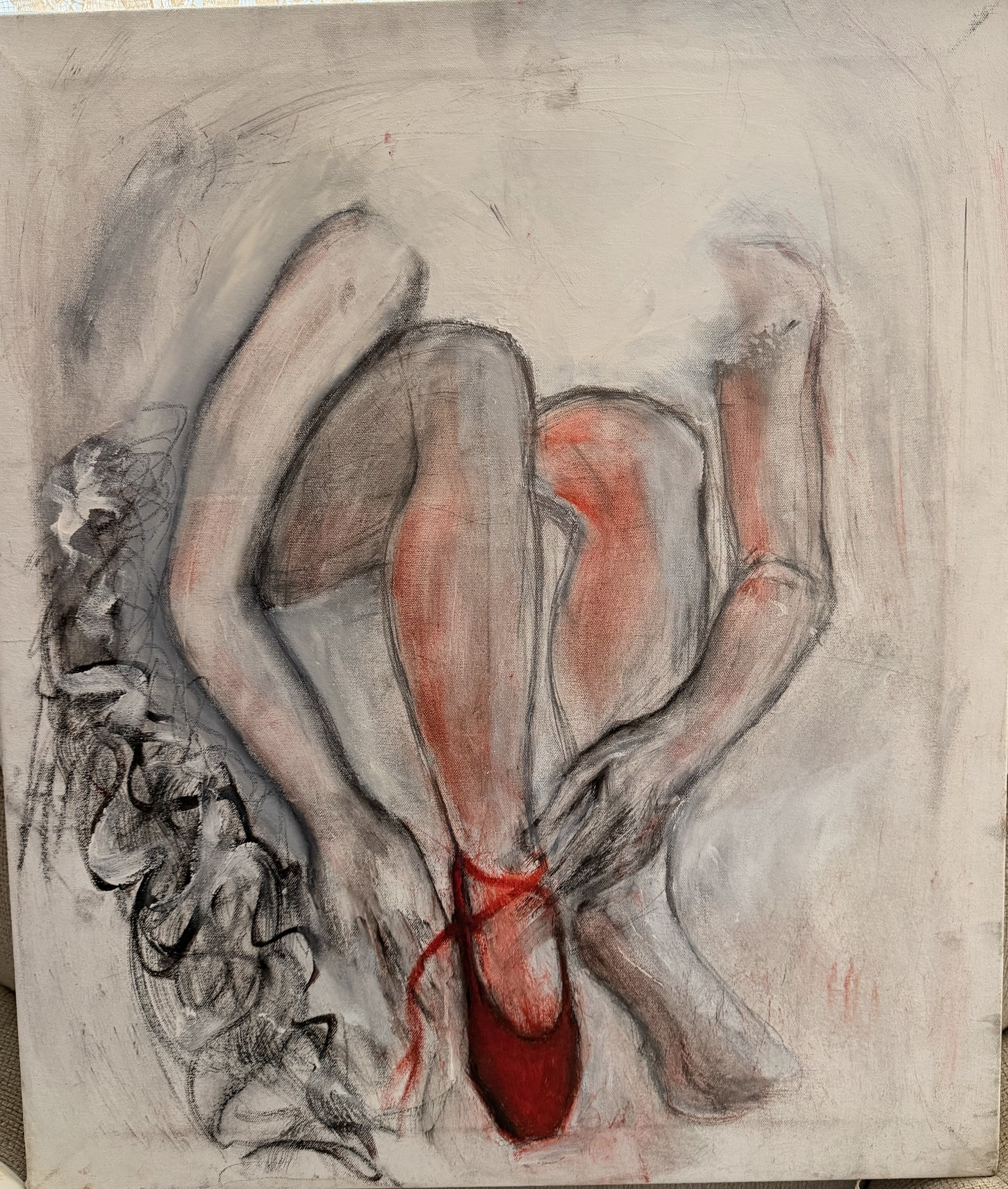 Charcoal and thin oil study of folded legs on a pale ground, with a single deep red slipper anchoring the composition